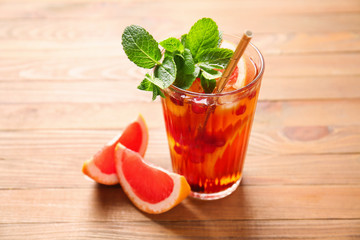 Glass of cold tea on wooden table
