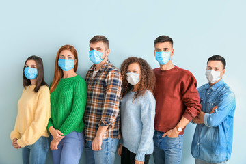 Group of people with protective masks on light background. Concept of epidemic