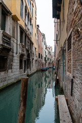 Narrow Canal mirroring the surrounding Houses, Venice/Italy