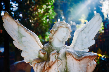 Death. Sad angel with urn with dust as symbol of pain, fear and end of life. Ancient statue.