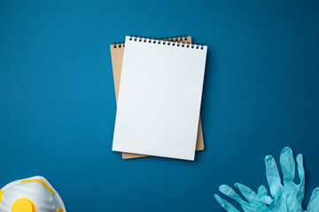 Notepad medical gloves and protective face mask.