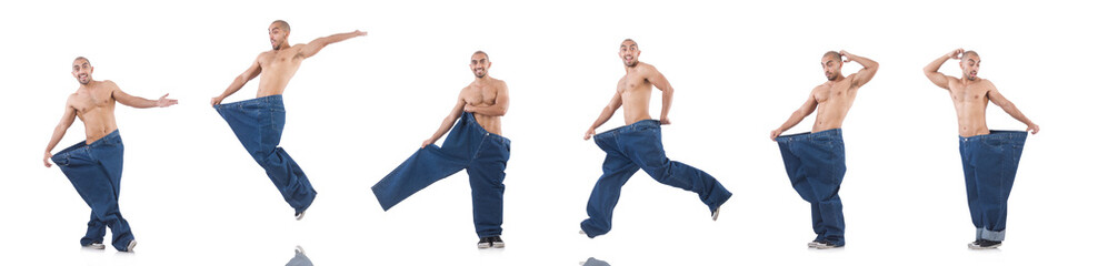 Man in dieting concept with oversized jeans