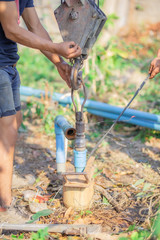 Pipe wrench used for well maintenance.Pipeline to the underground water pipe on a blurred background.