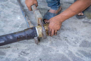 Pipe wrench used for well maintenance.Water pipes leaked into the concrete groundwater tank.