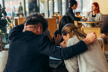 Group of young multiethnic friends bonding and having fun in a coffee shop