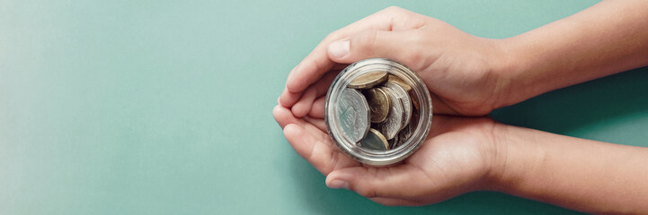 child hands holding money jar,  donation, saving, fundraising charity, family finance plan concept, , superannuation, financial crisis, stagflation concept - obrazy, fototapety, plakaty