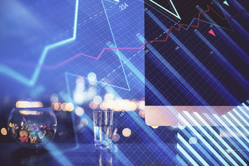 Financial graph colorful drawing and table with computer on background. Double exposure. Concept of international markets.