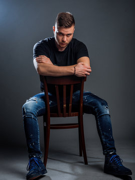 Stylish trendy man sitting on cheir