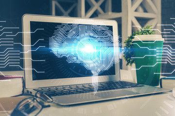 Double exposure of work space with computer and human brain drawing hologram. Brainstorm concept.
