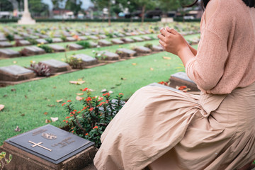 Close-Up of Religious Christian Woman Hands Clasped While Honoring and Praying to Military in War...