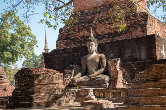 An ancient buddha statue in a historical park