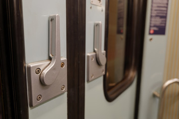 Close up interior view at vintage style of controlling handle for open doors of German train.
