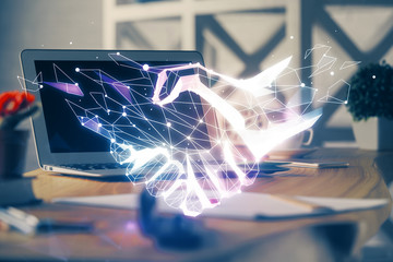 Desktop computer background in office and handshake hologram drawing. Double exposure. Pertnership...