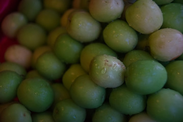 Water droplet on Monkey apple surface on a pile in a market