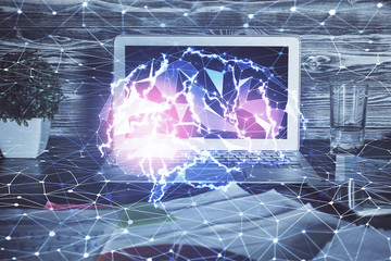 Double exposure of table with computer and brain hologram. Data innovation concept.