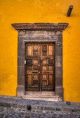 An old interesting door with a beautiful stone frame