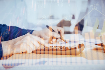 Financial trading graph multi exposure with man desktop background.