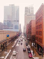 The way forward on city street with snow falling. Aerial view in West Loop, Chicago.