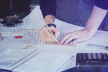 Double exposure of man writing on paper with forex graph.