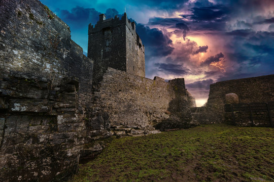 An ancient old castle in Ireland with a storm and lightning landscape