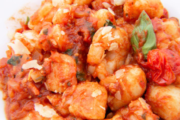 Gnocchi with tomato sauce and garnshied basil and cheese