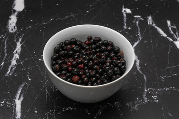 Dark blue small grapes or Vaccinium meridionale, agraz, close up.