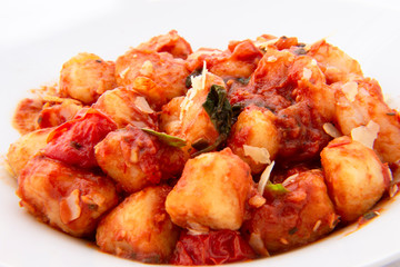 Gnocchi with tomato sauce and garnshied basil and cheese