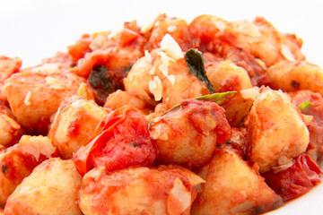 Gnocchi with tomato sauce and garnshied basil and cheese