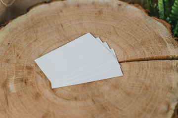 Business card mockup on wooden table with plants. Business card template. Corporate stationery set. Business card mockup on rustic composition. Top view.