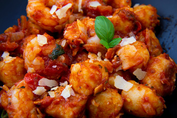 Gnocchi with tomato sauce and garnshied basil and cheese