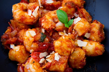 Gnocchi with tomato sauce and garnshied basil and cheese