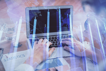 Multi exposure of forex graph with man working on computer on background. Concept of market...