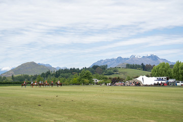 Fototapeta na wymiar Polo field in wide angle with new zealand mountains on the background