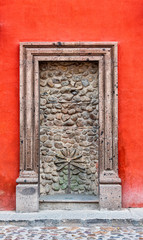A doorway that has been closed up with a stone wall 