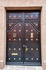 Fototapeta premium A beautifully kept old Dark wood door with brass studs 