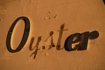 Old oyster lettering on back of building. Portland, Maine