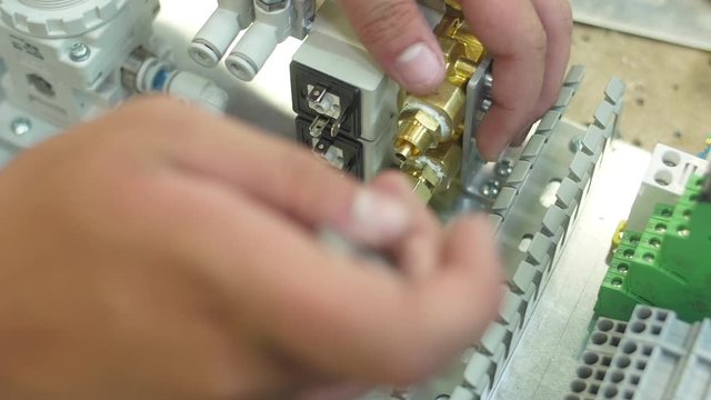 tighten brass nut with wrench in pneumatic automation system