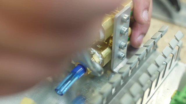 tighten brass nut with wrench in pneumatic automation system