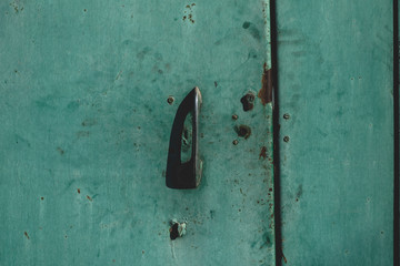 Metal door with vintage handles and rust with space for text