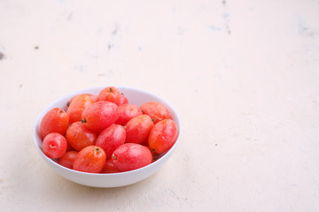 Elaeagnus berry in white bowl on backdrop,copy space,fruit of thailand