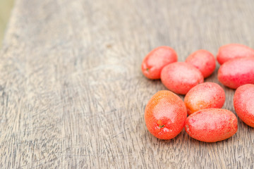 Elaeagnus berry in on wooden backdrop,copy space,fruit of thailand