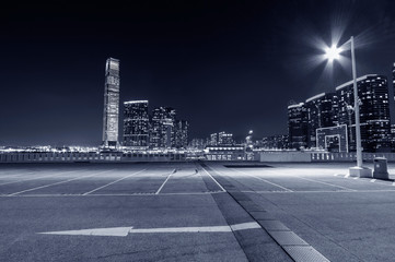 empty car park with city skyline background
