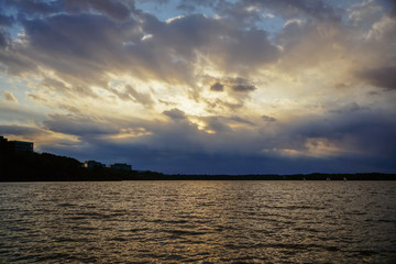 Fototapeta na wymiar A lake sunset with a real pareidolia cloud formation that looks like a man's face.