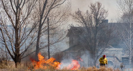 Fototapeta premium Firefighter Saves Home from Wildfire