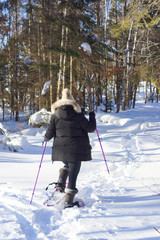 femme en raquettes dans la neige