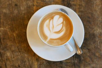 Fresh flavored coffee art on wooden background.