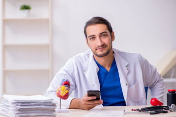 Young male doctor cardiologist working in the clinic