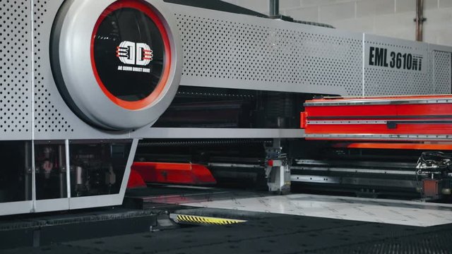 CNC machine automatically punching holes in high tech sheet metal factory