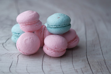 close up of blue color macaroon on wooden table 