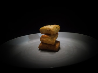 A plate of fish cake isolated on black background